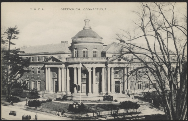 a large building with columns and a flag